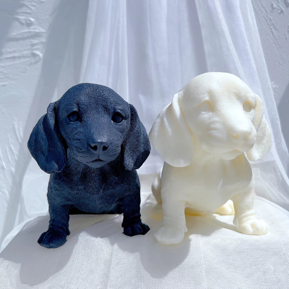 Dark blue and cream seated puppy castings with floppy ears and small paws