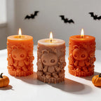 Close view of stitched dolls and ghosts on three pillar candles