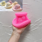 Pink gingerbread cowboy hat silicone mold held in one hand