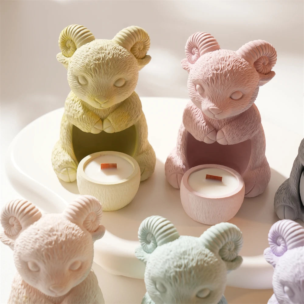 Pastel ram-shaped decorative holder samples showing seated poses and spiral horns