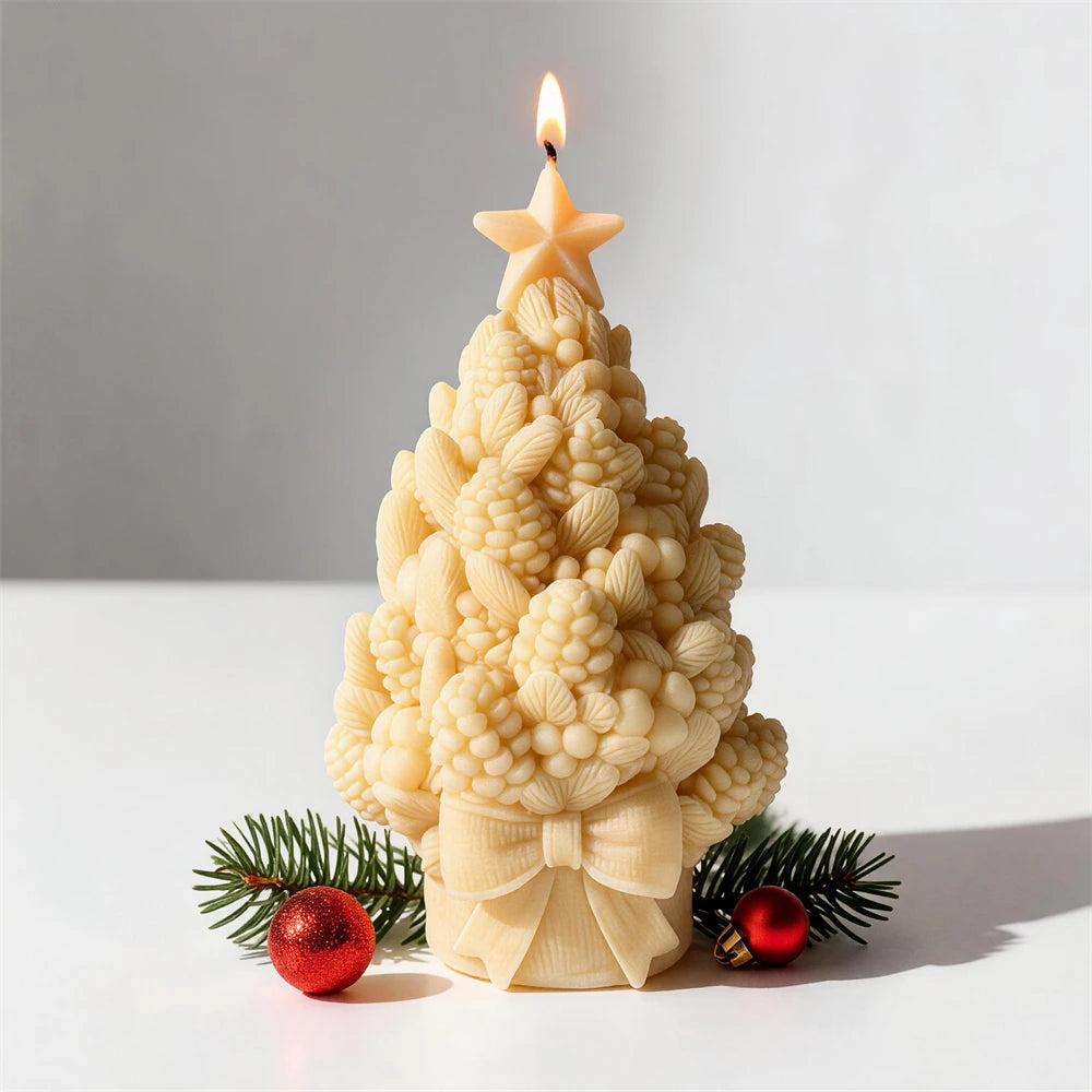 Single yellow pinecone tree candle beside a red ornament