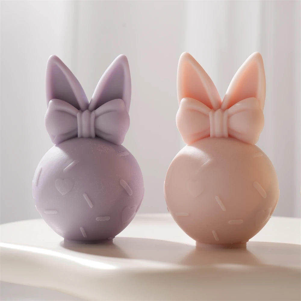 Purple and peach bunny eggs with upright ears and large bows