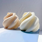 Beige and ivory spiral-ribbon figures side by side