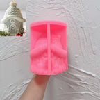Pink silicone snow roof cottage mold held open in a hand