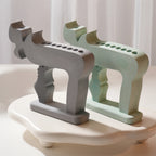 Gray and green Chai-shaped holder castings with rows of circular candle openings