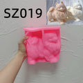 Pink standing Pomeranian silicone mold held in one hand