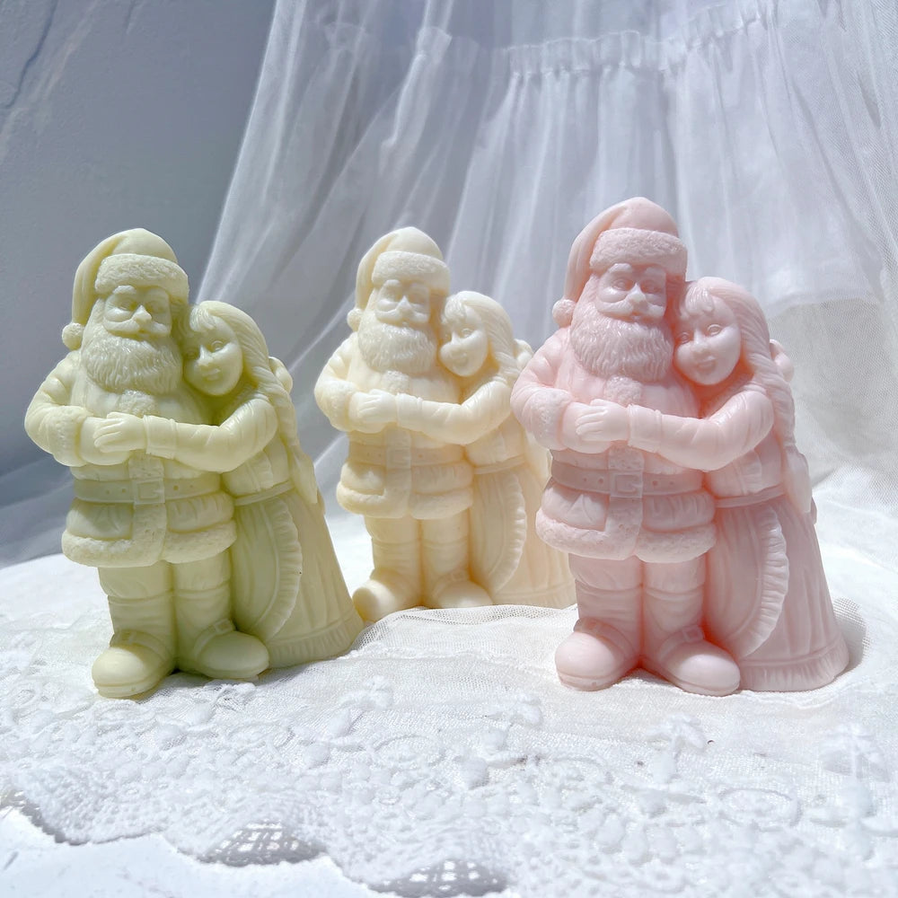 Three Santa couple castings showing joined arms and long skirts