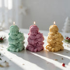 Mint mauve and yellow seated Santa candles cuddling small reindeer