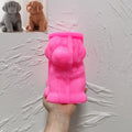 Pink silicone sitting puppy mold shown in hand with finished puppy examples