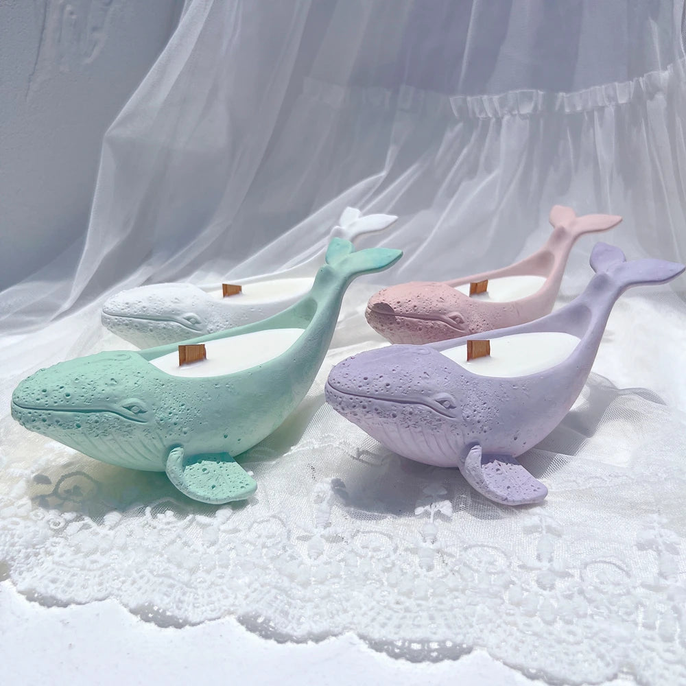 Whale-shaped holders showing long bodies and upturned tails