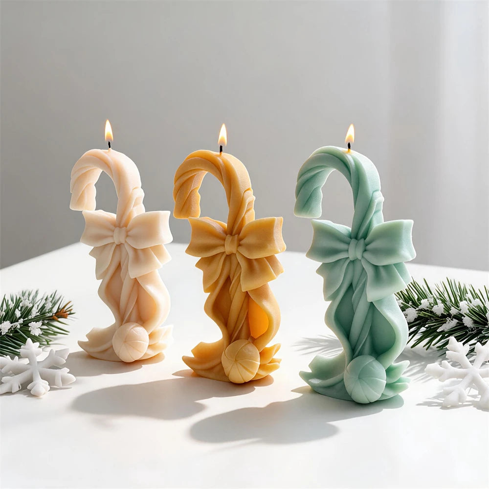 Three twisted canes with large bows and round candy bases