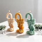 Three twisted canes with large bows and round candy bases