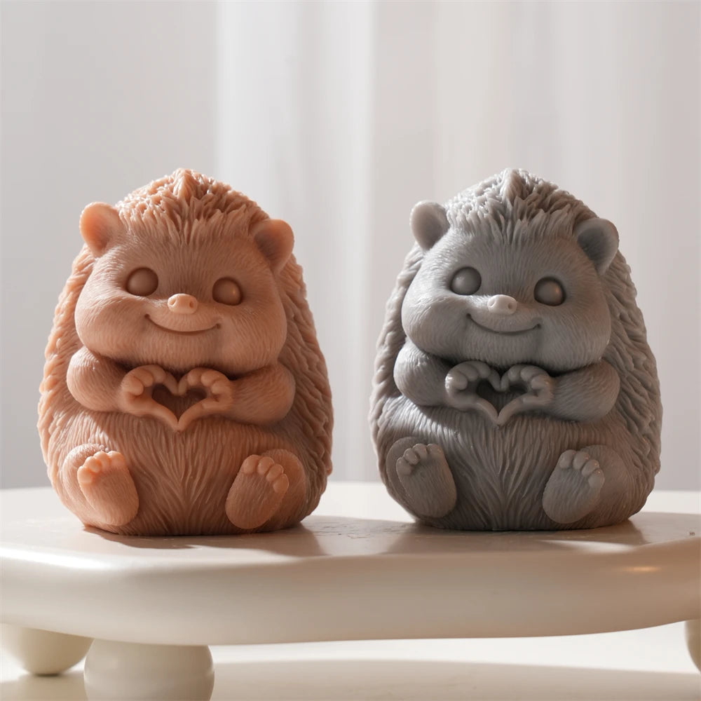 Orange and grey seated hedgehog castings with heart-shaped paws