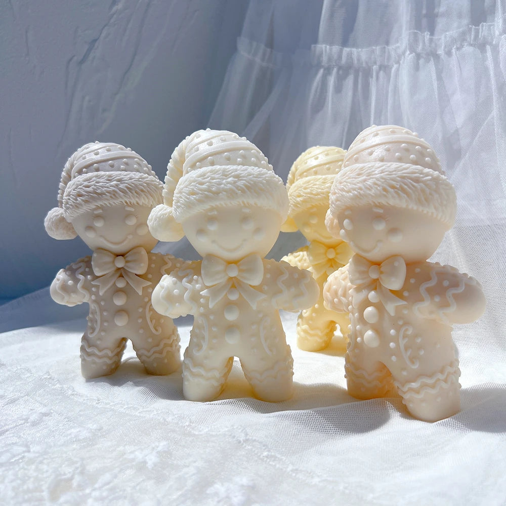 Group of textured gingerbread man candles in warm holiday colors