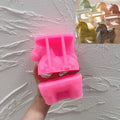 Pink silicone mold used to cast the hollow ornate horse holder