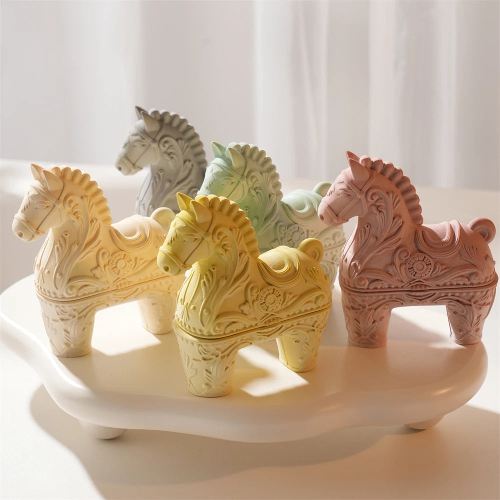 Ornate horse holders with open upper section arranged on a display