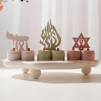 Four Hanukkah-inspired decorative motifs and paired-cup castings on a display tray