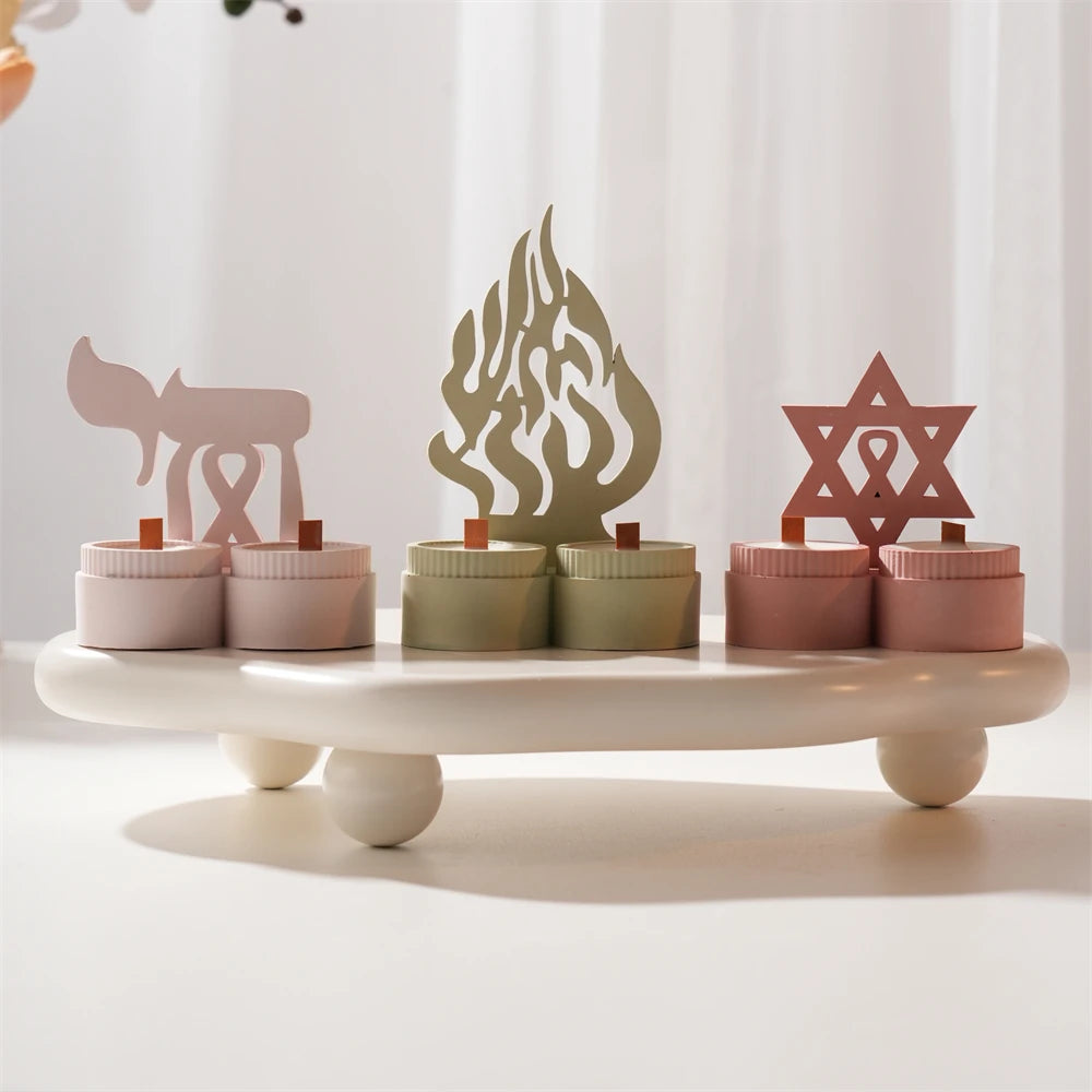 Four Hanukkah-inspired decorative motifs and paired-cup castings on a display tray