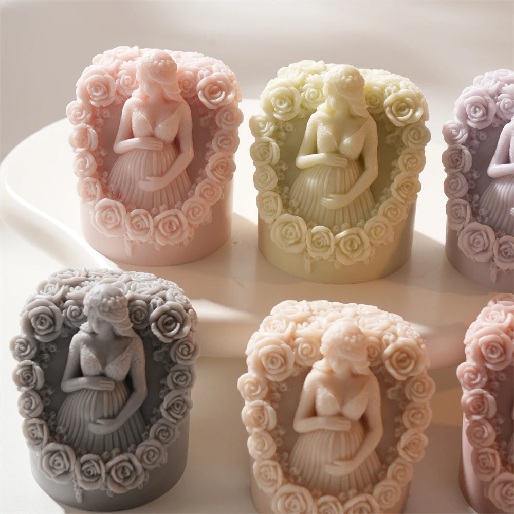 Close group of rose-bordered pregnancy figure castings
