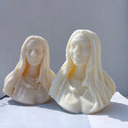 Two woman bust candle castings in warm light