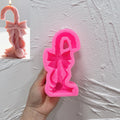 Pink silicone candy cane mold with bow-shaped cavity