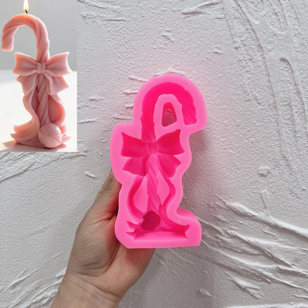 Pink silicone candy cane mold with bow-shaped cavity