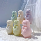 Russian nesting doll candle castings arranged on a white textured surface