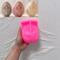 Pink silicone ballerina egg mold beside finished examples