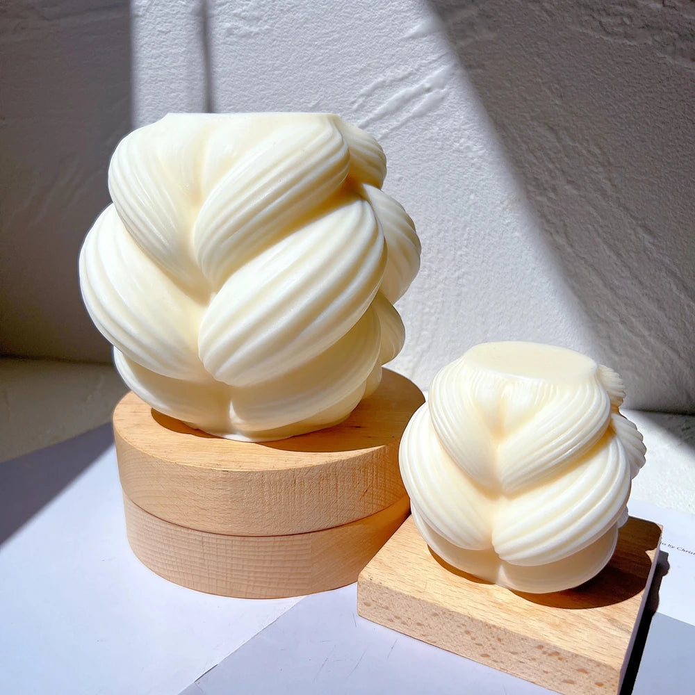 Braided-swirl figures displayed on wooden blocks