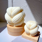 Braided-swirl figures displayed on wooden blocks