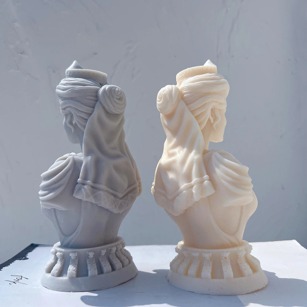 Profile and rear views of queen bust sculptures