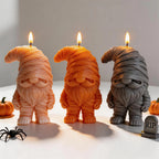 Mummy gnome candle samples beside a small decorative gravestone