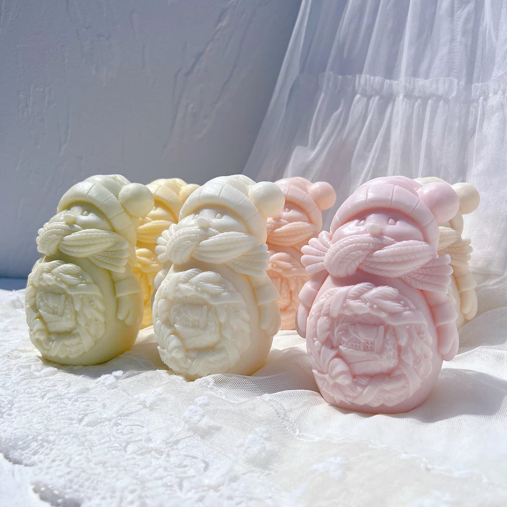 Three snowman family castings on a lace surface