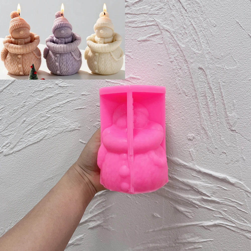 Pink silicone snowman mold held in one hand