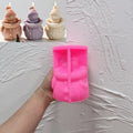 Pink silicone snowman mold held in one hand