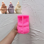 Pink silicone snowman mold held in one hand