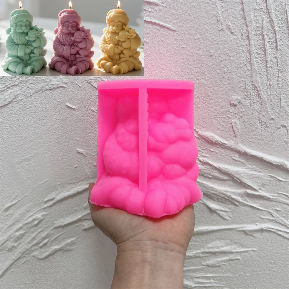 Pink silicone mold cavity for seated Santa holding a small reindeer