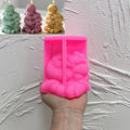 Pink silicone mold cavity for seated Santa holding a small reindeer