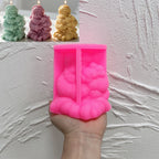 Pink silicone mold cavity for seated Santa holding a small reindeer