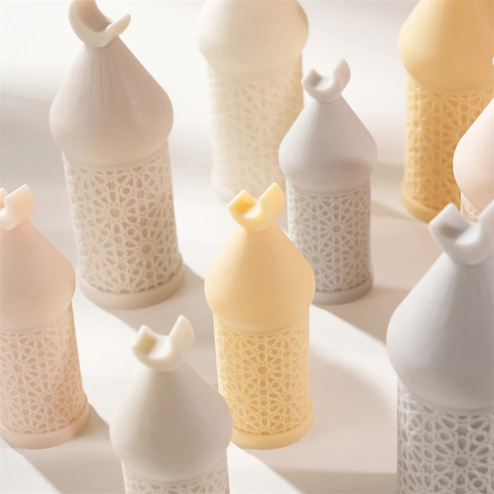 Close view of textured Ramadan candle pillars with small crescent finial tops