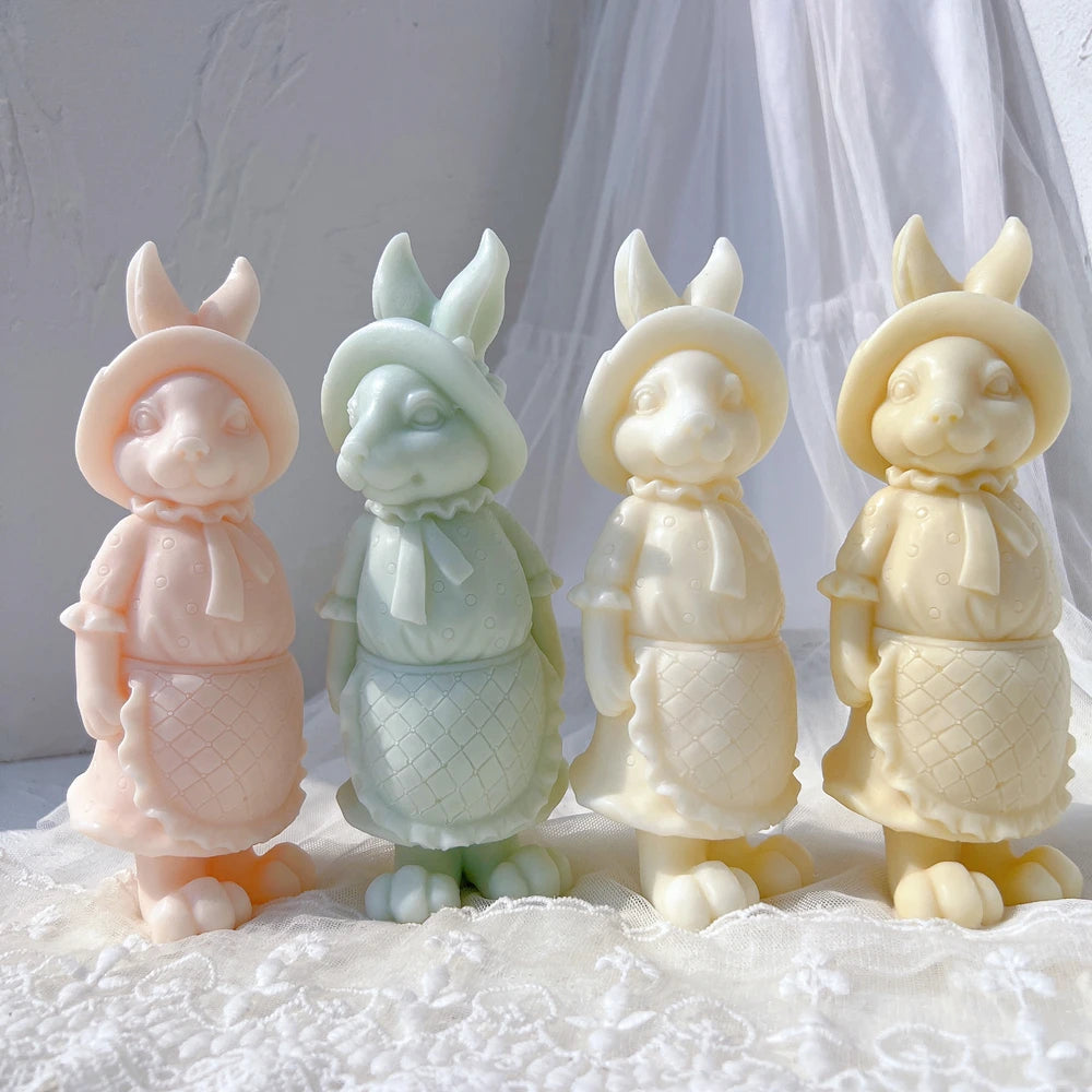 Four apron-wearing rabbit candle samples viewed from the front
