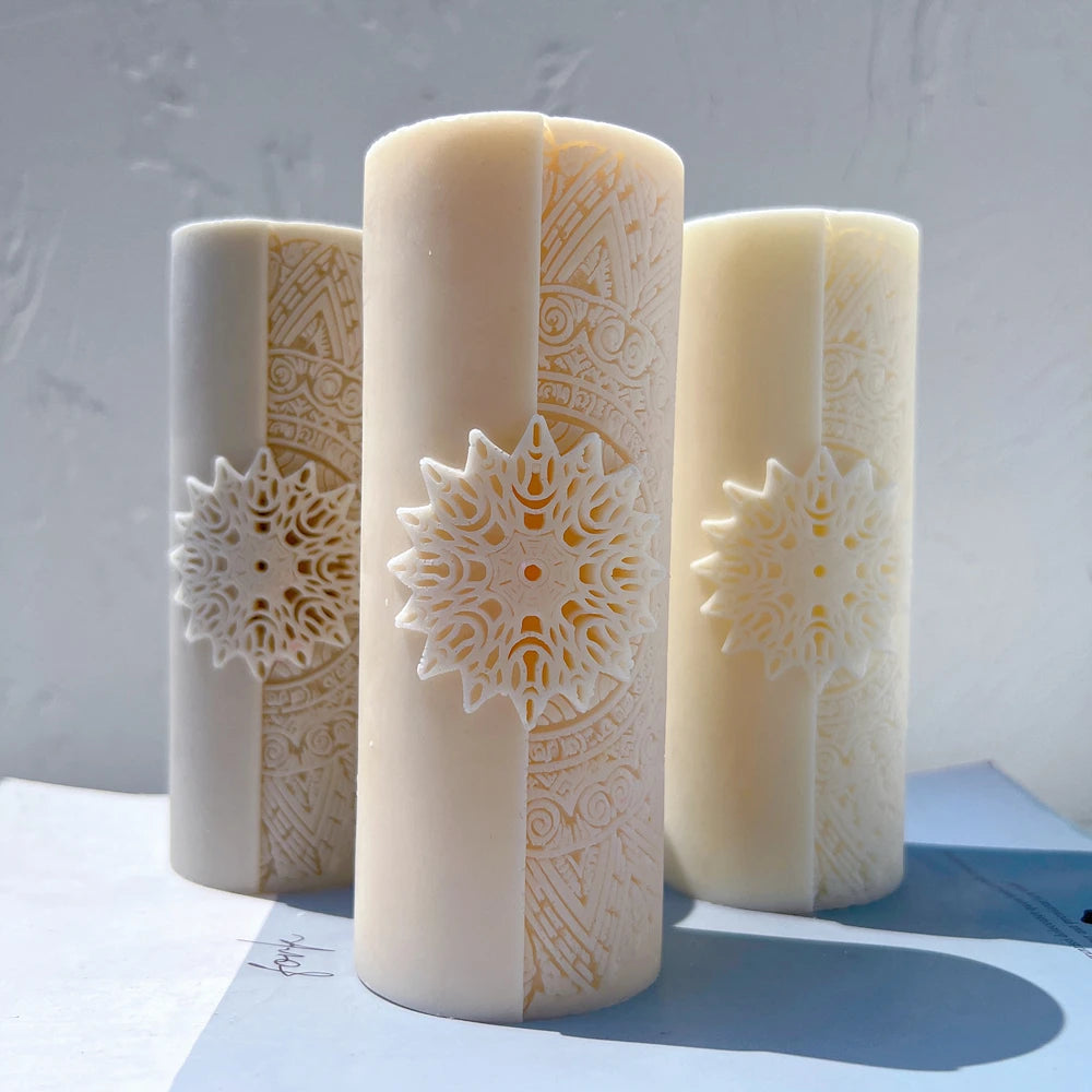 Cylindrical candles with floral mandala medallions and patterned bands
