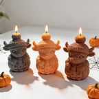 Angled group of cow-and-pumpkin Halloween candle examples