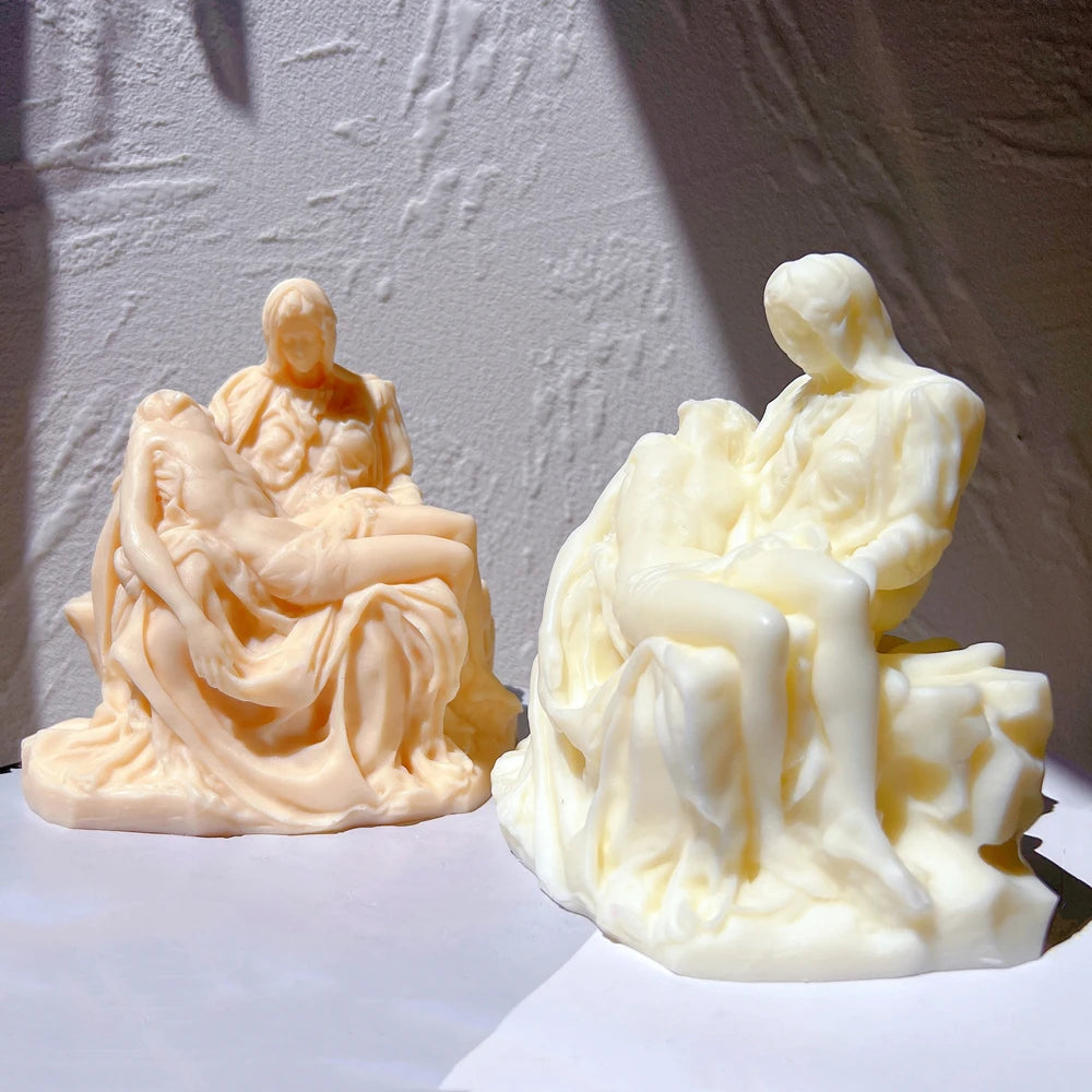 Peach and cream Pietà sculpture castings displayed together
