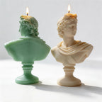 Rear view of classical bust candles showing sculpted hair and drapery