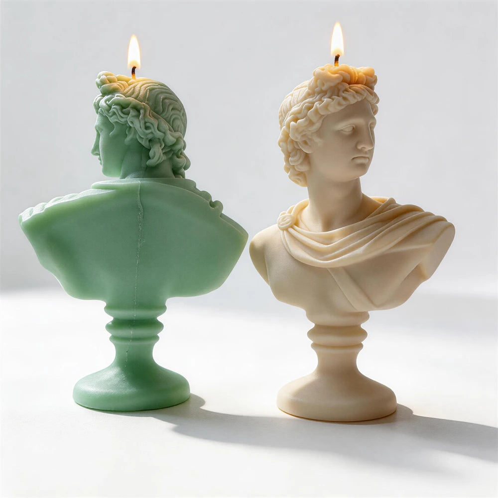 Rear view of classical bust candles showing sculpted hair and drapery
