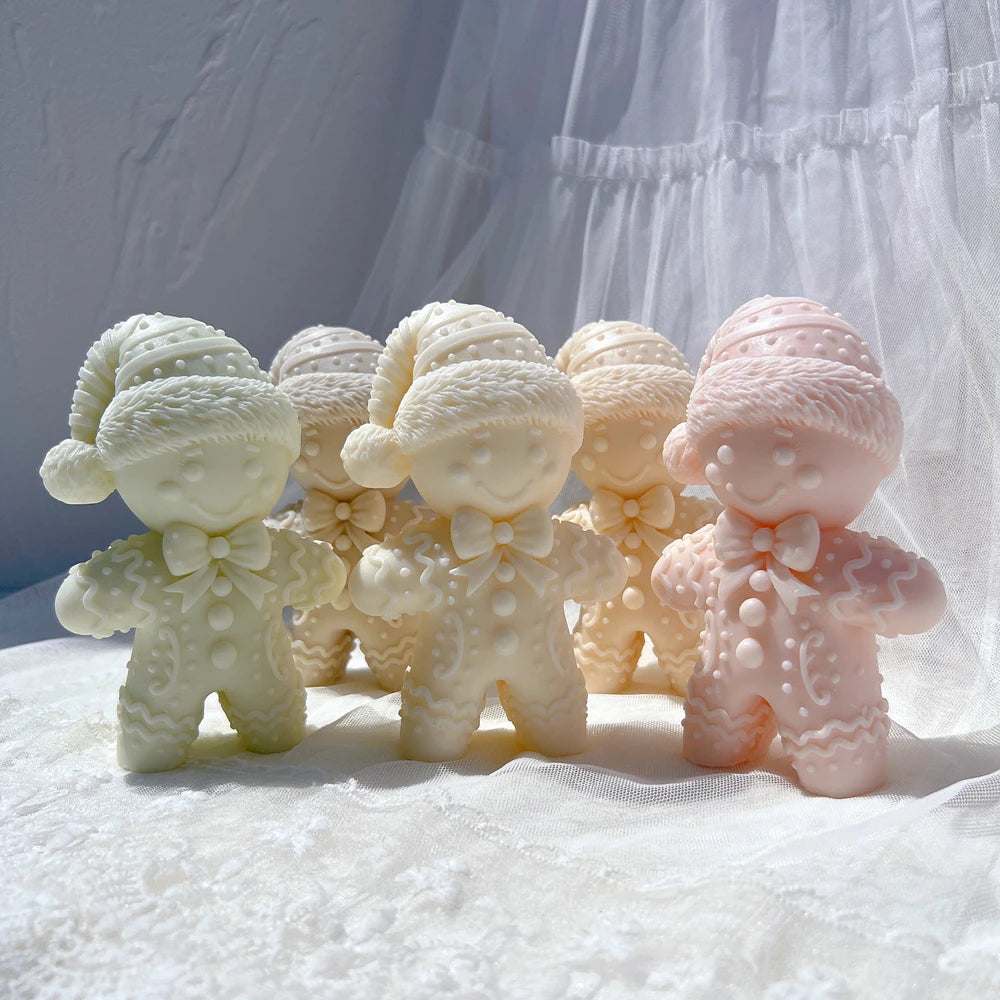 Winter-hat gingerbread figure candles in pastel wax colors