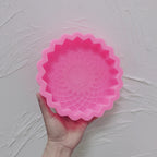 Pink Allah calligraphy rosette silicone mold held in one hand