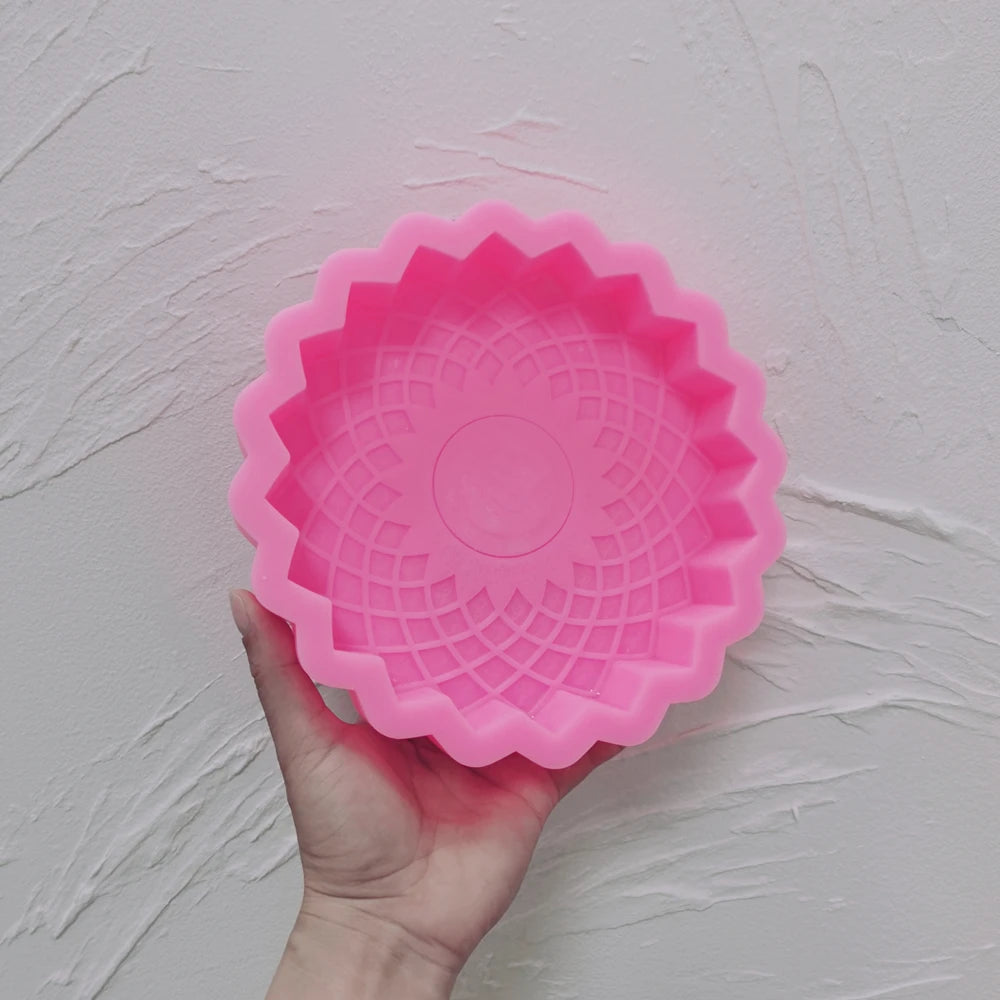 Pink Allah calligraphy rosette silicone mold held in one hand