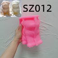 Pink pug silicone candle mold held in one hand